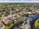 An aerial view shows beautiful waterfront homes with lush landscaping and a well-maintained community at 4173 Hearthstone Dr, Sarasota, FL 34238