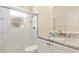 Well-lit bathroom featuring a shower with glass door and a granite vanity with white cabinets at 4173 Hearthstone Dr, Sarasota, FL 34238