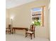 Bright bedroom featuring two chairs, a table, tile floor, and a window offering outdoor views at 4173 Hearthstone Dr, Sarasota, FL 34238