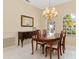 Bright dining room featuring a chandelier, wood table with chairs, and neutral walls at 4173 Hearthstone Dr, Sarasota, FL 34238