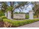 A beautifully landscaped entrance welcomes you to the Huntington Pointe community at 4173 Hearthstone Dr, Sarasota, FL 34238