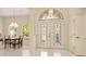 Open foyer with decorative stained glass doors, chandelier, and direct access to the dining area at 4173 Hearthstone Dr, Sarasota, FL 34238