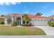 Charming front exterior of a single-story home with a well-manicured lawn at 4173 Hearthstone Dr, Sarasota, FL 34238