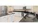 Spacious kitchen featuring white cabinets, stainless appliances and dark granite countertops at 4173 Hearthstone Dr, Sarasota, FL 34238