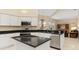 Modern kitchen featuring white cabinets, granite countertops, and stainless steel appliances at 4173 Hearthstone Dr, Sarasota, FL 34238