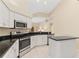Bright kitchen features stainless steel appliances, granite countertops, and white cabinets at 4173 Hearthstone Dr, Sarasota, FL 34238