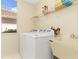 Bright laundry room with a modern washer and dryer and utility sink at 4173 Hearthstone Dr, Sarasota, FL 34238