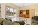 Inviting living room with tile floors, a ceiling fan, and sliding glass doors to the lanai at 4173 Hearthstone Dr, Sarasota, FL 34238