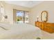 Bright main bedroom with sliding doors to lanai and en-suite bathroom at 4173 Hearthstone Dr, Sarasota, FL 34238