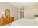 Bright main bedroom featuring a large dresser, neutral color palette, and access to en-suite bathroom at 4173 Hearthstone Dr, Sarasota, FL 34238