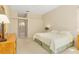 Comfortable main bedroom with neutral tones and dresser, with an adjoining bathroom at 4173 Hearthstone Dr, Sarasota, FL 34238