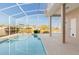Screened in pool with lake view and outdoor seating area at 4173 Hearthstone Dr, Sarasota, FL 34238