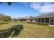 Spacious backyard with green lawn, landscaping, and screened lanai at 4348 Bowling Green Cir # 9, Sarasota, FL 34233