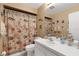 Bathroom featuring a shower/tub combo, tile floors and a decorative shower curtain at 4348 Bowling Green Cir # 9, Sarasota, FL 34233