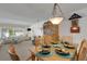 An open dining room with a large wooden display cabinet in the adjacent living room at 4348 Bowling Green Cir # 9, Sarasota, FL 34233