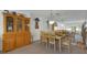 Bright dining area with a wooden table, six chairs and a view of the living room at 4348 Bowling Green Cir # 9, Sarasota, FL 34233
