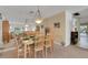 Inviting dining room with table set for a meal and a decorative hanging light fixture at 4348 Bowling Green Cir # 9, Sarasota, FL 34233