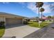 Exterior view of a residential home with a driveway, garage, and manicured lawn with patriotic flags at 4348 Bowling Green Cir # 9, Sarasota, FL 34233