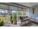 Relaxing sunroom with tile flooring, large windows, and peaceful water view; ideal for leisure at 4348 Bowling Green Cir # 9, Sarasota, FL 34233