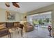 Bright living room with tile floors leads to the screened lanai overlooking the backyard and water view at 4348 Bowling Green Cir # 9, Sarasota, FL 34233