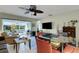 Spacious living room with tile floors, ceiling fan and large windows at 4348 Bowling Green Cir # 9, Sarasota, FL 34233