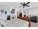 Spacious main bedroom featuring a ceiling fan, carpet floors and ensuite bathroom at 4348 Bowling Green Cir # 9, Sarasota, FL 34233