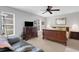 Cozy main bedroom featuring carpet floors, a ceiling fan, and a large window at 4348 Bowling Green Cir # 9, Sarasota, FL 34233