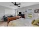 Comfortable main bedroom featuring carpet floors, a ceiling fan, and a large window at 4348 Bowling Green Cir # 9, Sarasota, FL 34233