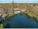 An aerial view showcases this beautiful home nestled alongside a tranquil pond and lush greenery at 4540 Murdock Ave, Sarasota, FL 34231