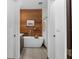 Modern bathroom featuring a soaking tub, wood paneling, and a tiled shower at 4540 Murdock Ave, Sarasota, FL 34231