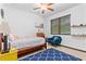 Bright bedroom features ceiling fan, natural light, accent chair and charming decor elements at 4540 Murdock Ave, Sarasota, FL 34231