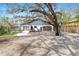 Lovely home featuring an oversized front lawn and a welcoming porch, set against a backdrop of mature trees at 4540 Murdock Ave, Sarasota, FL 34231