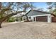 A well-maintained home with a spacious driveway and manicured landscaping, adjacent to a tranquil pond at 4540 Murdock Ave, Sarasota, FL 34231