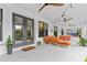 Relaxing patio featuring comfortable seating, ceiling fans, string lights, and serene outdoor views at 4540 Murdock Ave, Sarasota, FL 34231
