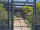 View through the lanai screen to a brick patio surrounding a private in-ground pool at 4725 Gleason Ave, Sarasota, FL 34242