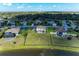 Aerial view of the property, boasting a large lawn near a picturesque lake and wooded area at 4789 Vasca Dr, Sarasota, FL 34240