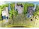 An aerial view shows a home's manicured lawn adjacent to a tranquil lake at 4789 Vasca Dr, Sarasota, FL 34240