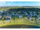Aerial view of a home with a sprawling lawn, nestled in a serene, lakeside community at 4789 Vasca Dr, Sarasota, FL 34240
