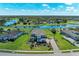 Aerial view of a large two-story house, with a beautiful lake, lush green lawn and mature trees at 4789 Vasca Dr, Sarasota, FL 34240