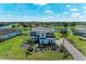 Stunning aerial view of a two-story home with tile roof, landscaped yard, and serene lake views at 4789 Vasca Dr, Sarasota, FL 34240
