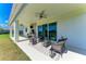 The back porch features a seating area, outdoor kitchen, ceiling fans, and sliding glass doors to the interior at 4789 Vasca Dr, Sarasota, FL 34240
