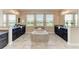 Bathroom featuring double sinks, a large soaking tub, and plenty of natural light at 4789 Vasca Dr, Sarasota, FL 34240