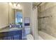 Bright bathroom featuring a shower-tub combo with decorative tile, granite countertops, and a modern vanity at 4789 Vasca Dr, Sarasota, FL 34240