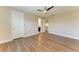 Spacious bedroom with modern ceiling fan, walk-in closet and hardwood floors at 4789 Vasca Dr, Sarasota, FL 34240