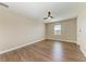A simply decorated bedroom with hardwood floors, ceiling fan, and neutral paint at 4789 Vasca Dr, Sarasota, FL 34240