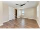 Bright bedroom featuring wood floors, neutral paint, and a ceiling fan; ensuite bathroom access is visible at 4789 Vasca Dr, Sarasota, FL 34240