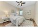 Bright bedroom with ceiling fan, hardwood floors and neutral décor at 4789 Vasca Dr, Sarasota, FL 34240