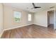 Bright bedroom with large windows, hardwood floors, ceiling fan, and neutral paint at 4789 Vasca Dr, Sarasota, FL 34240
