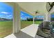 Spacious covered patio overlooking the backyard and scenic lake at 4789 Vasca Dr, Sarasota, FL 34240
