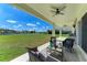 Comfortable outdoor seating area on a covered patio with lake views at 4789 Vasca Dr, Sarasota, FL 34240